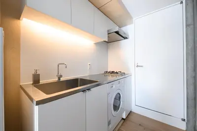 a kitchen with a sink and a washing machine at GRASS BLDG 401 in Tokyo