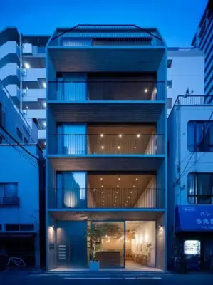 a tall building with a large window in a city at GRASS BLDG 401 in Tokyo