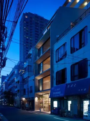 a tall building on a city street at night at GRASS BLDG 401 in Tokyo