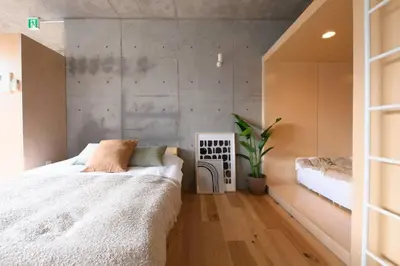 a bedroom with a bed and a potted plant at GRASS BLDG 401 in Tokyo
