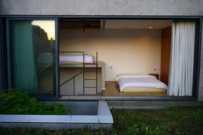 a bedroom with a bed on the balcony of a house at GRASS BLDG 501 in Tokyo