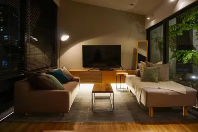 a living room with two couches and a flat screen tv at GRASS BLDG 501 in Tokyo