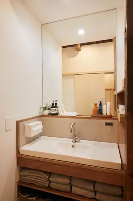a bathroom with a sink and a mirror at anchorAsakusa Vacation Rental in Tokyo
