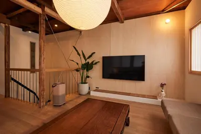 a living room with a flat screen tv on the wall at anchorAsakusa Vacation Rental in Tokyo