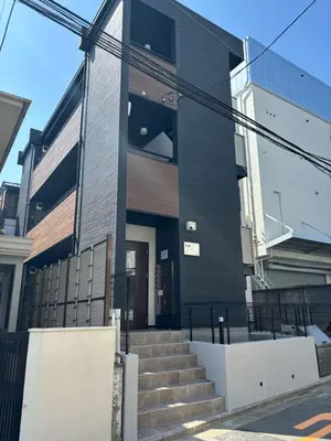 a black building with stairs in front of it at IXO Ts1 in Tokyo