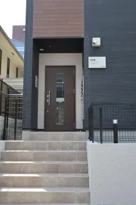 a building with stairs leading to a door at IXO Ts1 in Tokyo
