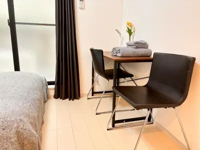 a bedroom with a desk and a chair and a bed at IXO Ts1 in Tokyo