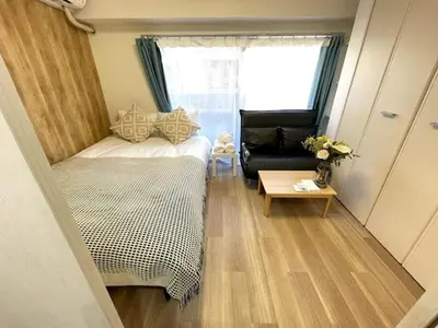 a small room with a bed and a couch at Nishi-Ike Apartment Room 2 in Tokyo