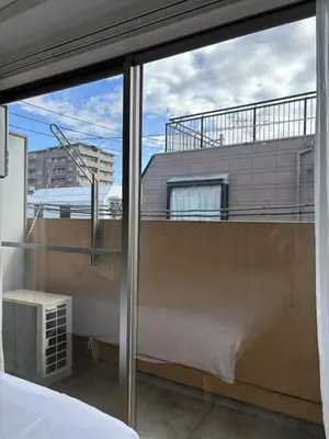 a view of a balcony from a bedroom window at Nishi-Ike Apartment Room 3 in Tokyo