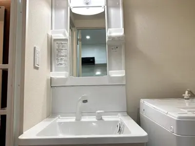a bathroom with a sink and a mirror at Nishi-Ike Apartment Room 3 in Tokyo