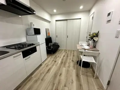 a small kitchen with a table and a stove at Nishi-Ike Apartment Room 3 in Tokyo
