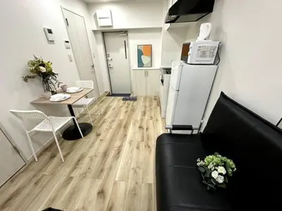 a living room with a couch and a table at Nishi-Ike Apartment Room 3 in Tokyo