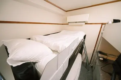 two beds in a small room with white sheets at 50m 2DK Private Condo!Center of Tokyo!5min Akasaka sta!! in Tokyo