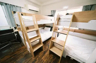 a dorm room with two bunk beds and a ladder at 50m 2DK Private Condo!Center of Tokyo!5min Akasaka sta!! in Tokyo