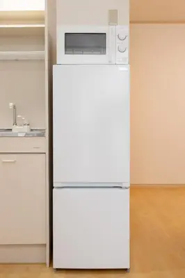 a white refrigerator in a kitchen with a microwave at Kagurazaka City House - \u795e\u697d\u5742\u30b7\u30c6\u30a3\u30cf\u30a6\u30b9 in Tokyo