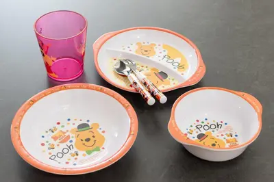 three plates with winnie the pooh characters and a glass at Kagurazaka City House - \u795e\u697d\u5742\u30b7\u30c6\u30a3\u30cf\u30a6\u30b9 in Tokyo