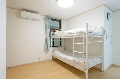 a room with two bunk beds in it at Kagurazaka City House - \u795e\u697d\u5742\u30b7\u30c6\u30a3\u30cf\u30a6\u30b9 in Tokyo