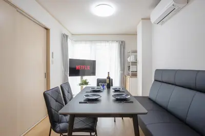 a living room with a table and a couch at Kagurazaka City House - \u795e\u697d\u5742\u30b7\u30c6\u30a3\u30cf\u30a6\u30b9 in Tokyo