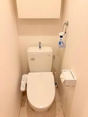 a bathroom with a white toilet with a scale on the wall at IXO Ts2 in Tokyo