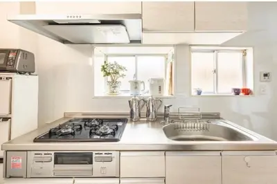 a kitchen with a sink and a stove at \u677f\u6771\u30d3\u30eb in Tokyo