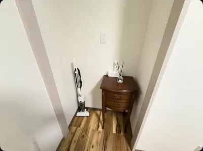 a room with a wooden floor and a table with a phone at Small stay in Tokyo in Tokyo