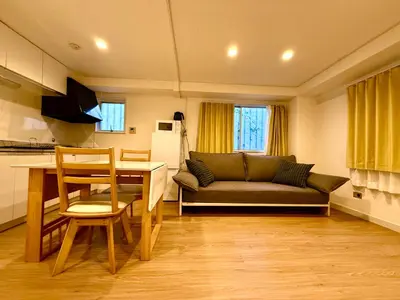 a living room with a couch and a table at Home SHINJUKU west 101 in Tokyo