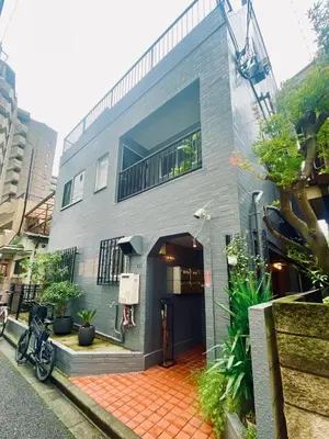 a gray house with a red brick courtyard at Home SHINJUKU west 101 in Tokyo