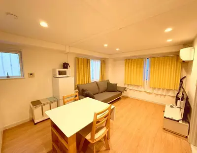 a living room with a couch and a table at Home SHINJUKU west 101 in Tokyo