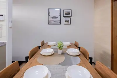 a dining room with a wooden table and chairs at Mikazuki Akabane/MA1 in Tokyo