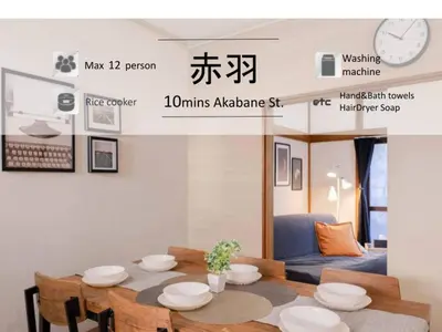 a dining room with a table with plates on it at Mikazuki Akabane/MA1 in Tokyo