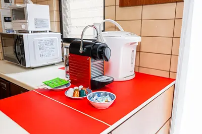 a red counter top with a coffee maker on it at KYARA Hotel\u30df\u30b9\u30df401 in Tokyo