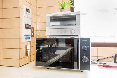 a microwave oven sitting on top of a counter at KYARA Hotel\u30df\u30b9\u30df401 in Tokyo