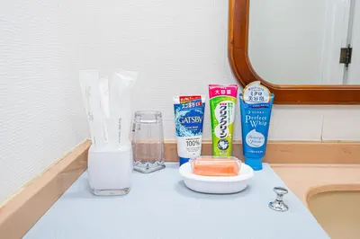 a counter with a sink with milk and other items on it at KYARA Hotel\u30df\u30b9\u30df401 in Tokyo