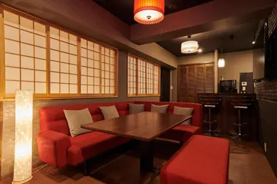 a restaurant with a red couch and a wooden table at \u7d44\u7d10\u306e\u9593 in Tokyo