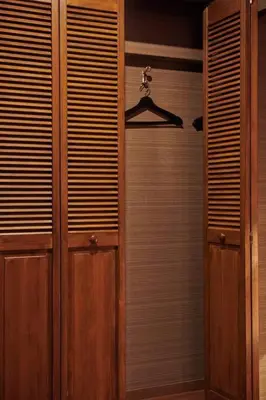 a closet with wooden doors and a hanger at \u7d44\u7d10\u306e\u9593 in Tokyo