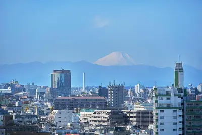 a view of a city with a mountain in the background at \u7d44\u7d10\u306e\u9593 in Tokyo