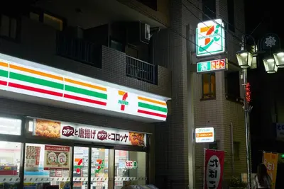 a store with neon signs on the side of a building at \u7d44\u7d10\u306e\u9593 in Tokyo