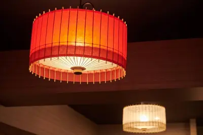 a large red chandelier hanging from a ceiling at \u7d44\u7d10\u306e\u9593 in Tokyo