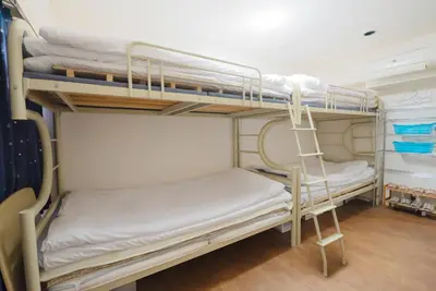 a group of bunk beds in a room at AKARENGA house in Tokyo