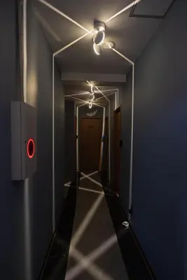 a corridor with a red light in a dark room at AKARENGA house in Tokyo
