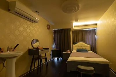a bedroom with a bed and a sink and a mirror at AKARENGA house in Tokyo