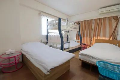 a room with two bunk beds and a table at AKARENGA house in Tokyo