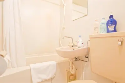 a bathroom with a sink and a bath tub at Shinjuku Waseda Earthtone Apartment in Tokyo