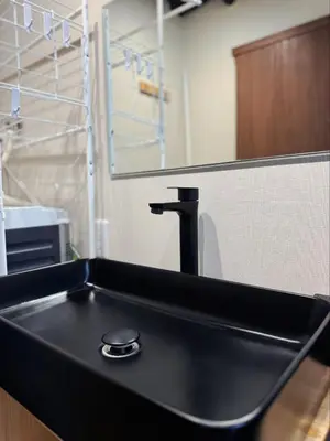 a black sink in a kitchen with a faucet at IKEBUKURO TOKIWA 10 BUILDING 6min walk from Ikebukuro Station Direct access to the airport in Tokyo