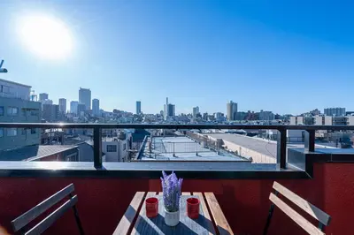 a balcony with a table and a view of a city at Aurora 2 in Tokyo