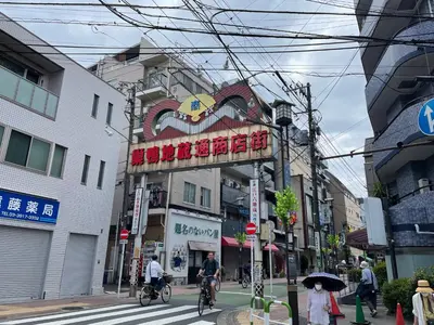 a group of people riding bikes down a city street at Aurora 2 in Tokyo