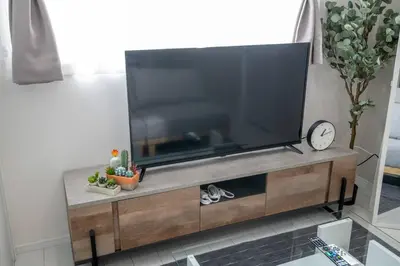 a large flat screen tv sitting on a entertainment center at \u30aa\u30fc\u30b7\u30e3\u30f3\u30ba\u30b9\u30a4\u30fc\u30c8 \u6771\u4eac\u30c7\u30a3\u30ba\u30cb\u30fc\u30ea\u30be\u30fc\u30c8\u30b3\u30fc\u30b8\u30fc\u30d0\u30eb\u30b3\u30cb\u30fc302 in Tokyo