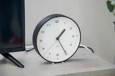 a clock sitting on a table next to a monitor at \u30aa\u30fc\u30b7\u30e3\u30f3\u30ba\u30b9\u30a4\u30fc\u30c8 \u6771\u4eac\u30c7\u30a3\u30ba\u30cb\u30fc\u30ea\u30be\u30fc\u30c8\u30b3\u30fc\u30b8\u30fc\u30d0\u30eb\u30b3\u30cb\u30fc302 in Tokyo