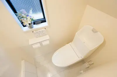 a white toilet in a bathroom with a window at Tokyo Kitaku hotel in Tokyo