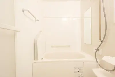 a white bathroom with a sink and a shower at Tokyo Kitaku hotel in Tokyo